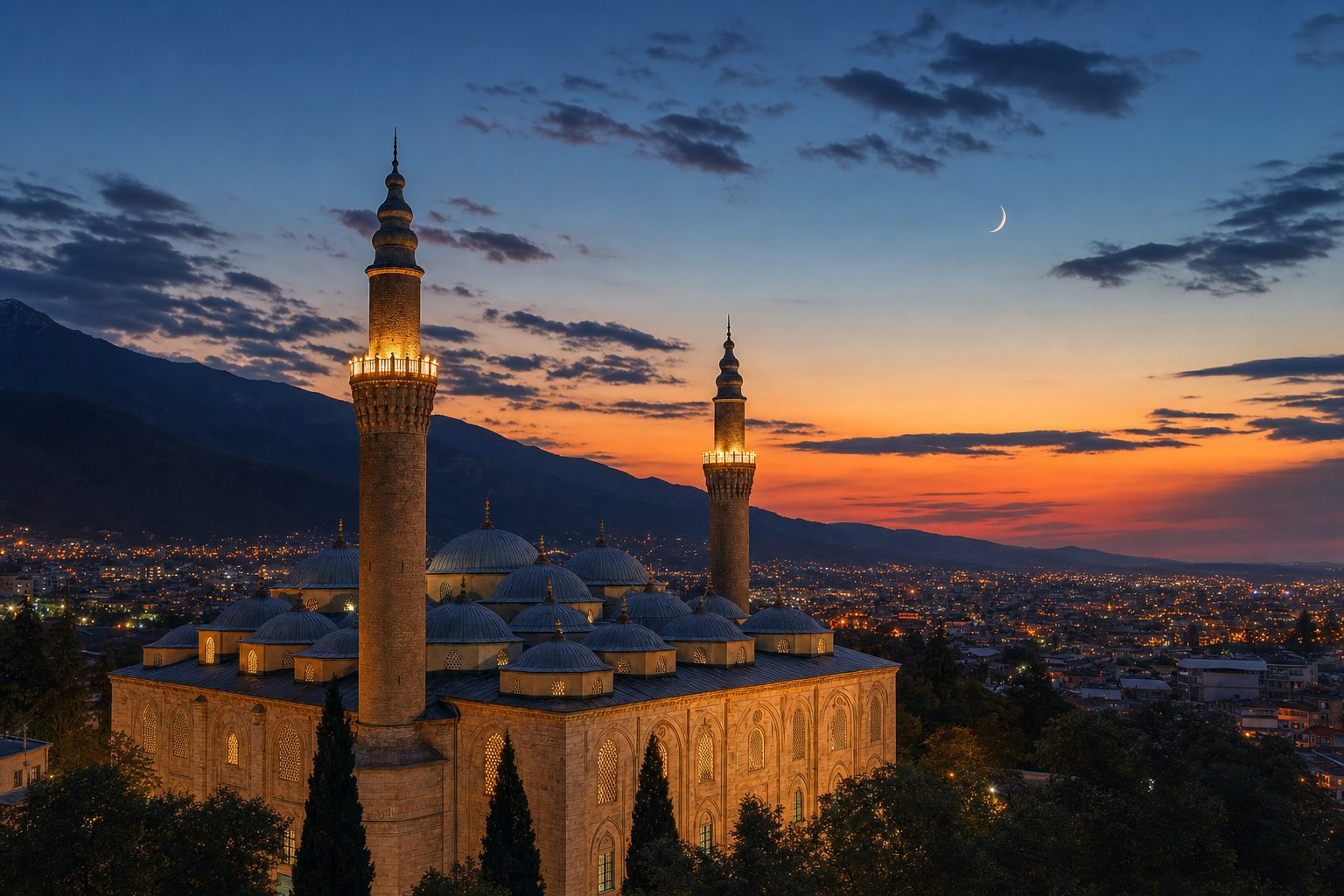 Uludağ eteğinde Bursa Ulu Camii — akşam vakti, gün batımı